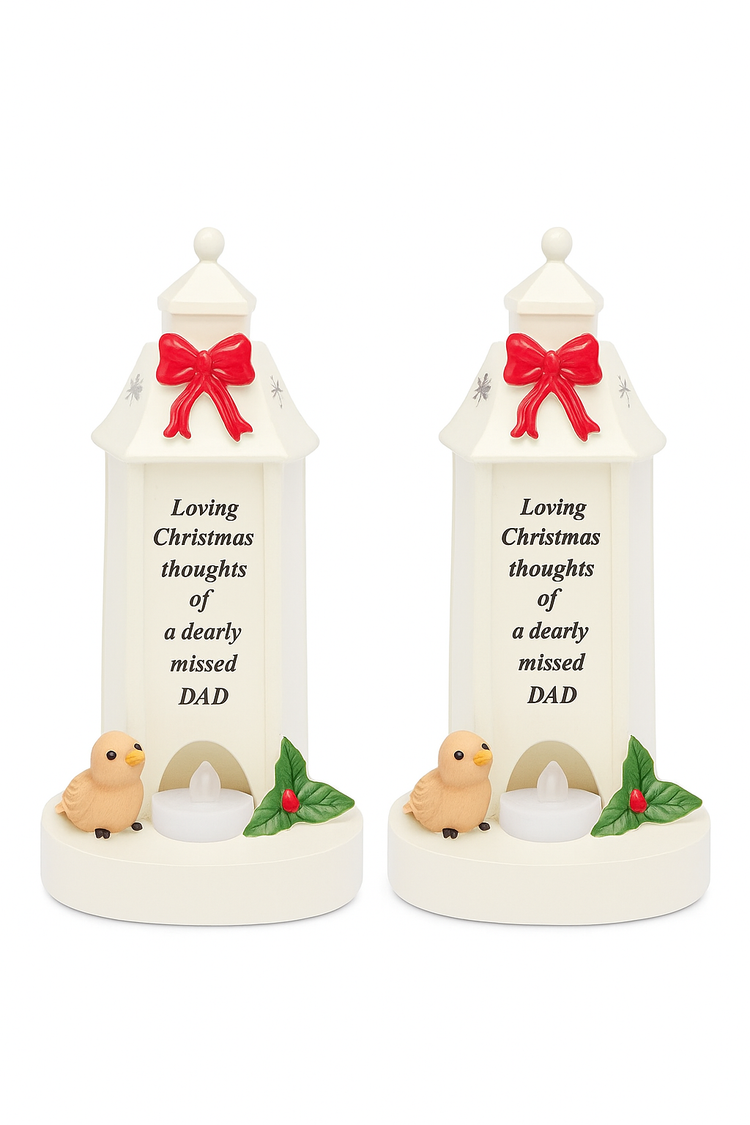 Loving Christmas ornament white lantern with red bow, small bird, candle and holly decoration in memory of a dearly missed dad