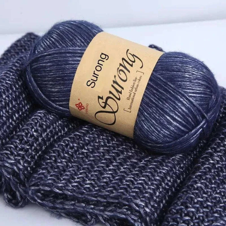 Premium softer yarn ball on knitted fabric, ideal for DIY knitting scarves and hats projects