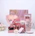 Aromatherapy candle gift set with candles, soap, mug, and floral accents in pink packaging