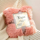pink super soft coral fleece blanket with fluffy texture on beige knitted fabric background