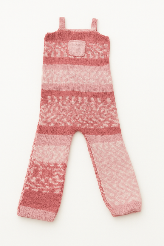 Pink and white knitted romper for babies with patterned design and shoulder straps