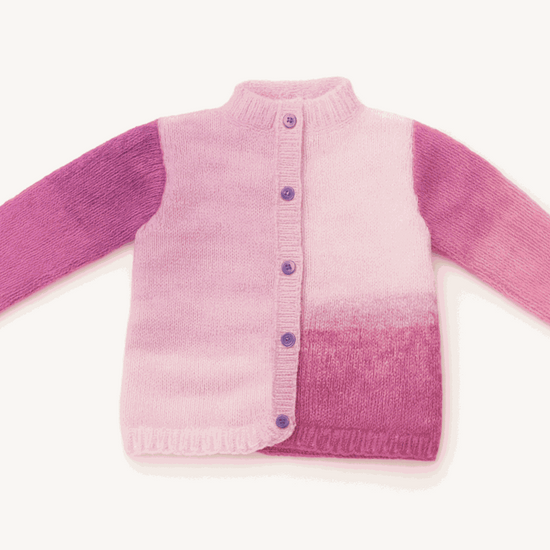 Kinetic cardigan in pink and purple gradient with button front and ribbed collar, combining comfort and modern style.