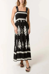 Black printed shirred bodice maxi dress with white floral patterns and ruffled straps