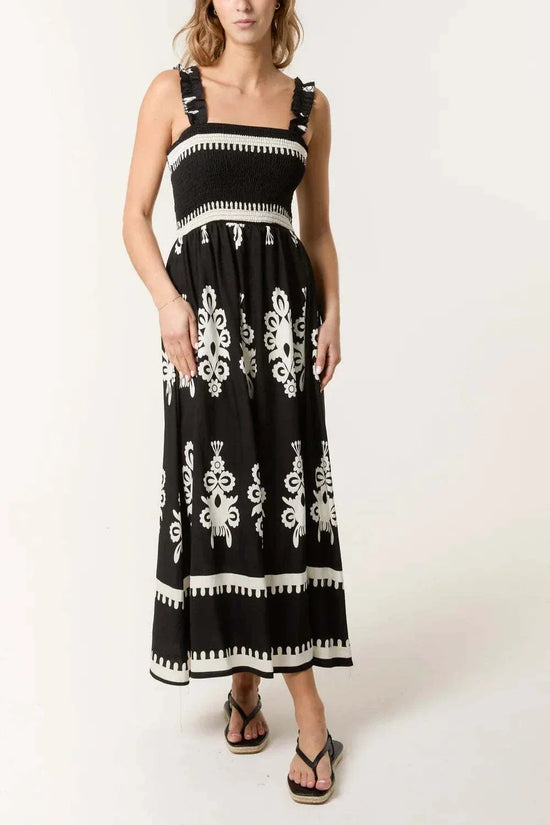 Black printed shirred bodice maxi dress with white floral patterns and ruffled straps