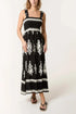 Black printed shirred bodice maxi dress with white floral patterns and ruffled straps