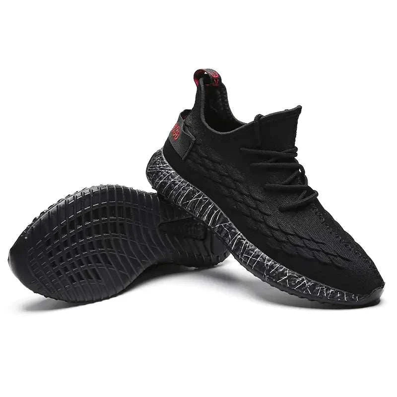 Black sports running shoes with textured design and comfortable sole held in hand