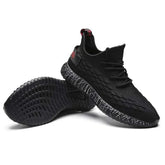 Black sports running shoes with textured design and comfortable sole held in hand