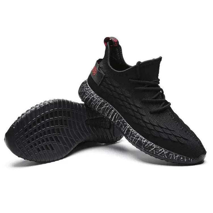 Black sports running shoes with textured design and comfortable sole held in hand
